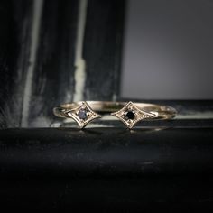 "\"Open star ring \" is a unique wedding band designed to accentuate your engagement ring that sits above. The style is sophisticated and dainty. The gap between two stars measures about 2~3mm, and it can be customized upon request. Details :: Material Option: 14k yellow, white, rose gold or platinum :: Band width: 1.3mm :: Height : 3.7mm :: Total diamond carat weight: .03ct :: Size of the gap between stars : 2~3mm :: Made with 100% recycled metal and ethically sourced gemstones. :: Design name: 14k White Gold Jewelry With Black Diamonds, Celestial Single Cut Diamond Promise Jewelry, Celestial Style Promise Jewelry With Single Cut Diamonds, Celestial Single Cut Diamond Promise Rings, Celestial Single Diamond Wedding Jewelry, Celestial Wedding Jewelry With Single Diamond, Elegant 14k Gold Rings With Black Diamonds, Anniversary Rose Gold Jewelry With Black Diamonds, Adjustable 14k Gold Rings With Rose Cut Diamonds