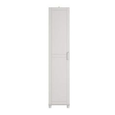 a tall white cabinet sitting on top of a white floor next to a wall mounted toilet