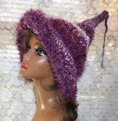 Beautiful shades of purple crochet witch/wizard costume hat.  Great for Halloween parties, cosplay events, trick or treating or just for fun.  Makes a nice gift for a witchy friend. Created with a mixture of purple and pink acrylic yarns, eyelash yarn and specialty yarns. Hand wash with a mild detergent and lay flat to dry. 18" brim to tip fits most adults or teens Adjustable Purple Hat For Costume, Purple Adjustable Hand Knitted Hat, Adjustable Purple Hand Knitted Hat, Purple Hats For Halloween Costume Party, Purple Hand Knitted Adjustable Hat, Purple Costume Hats And Headpieces For Halloween, Adjustable Purple Hand-knitted Hat, Adjustable Hand-knitted Purple Hat, Purple Halloween Party Hat