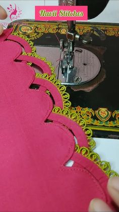 someone is using a sewing machine to sew on pink material with yellow trimmings