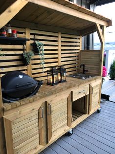 an outdoor kitchen with grill and sink on the deck