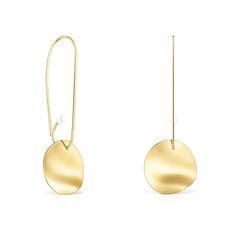 the gold disc earrings are hanging from long hooks, with a small pearl in the center