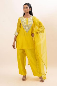 Yellow kurta with floral embroidered yoke and cuffs. Paired with a pant and dupatta.
Components: 3
Pattern: Hand Embroidery
Type Of Work: Floral, Chid, Pearls
Neckline: Round Neck
Sleeve Type: Three Quarter Sleeves
Fabric: Kurta: Chanderi, Pant: Bamber Silk, Dupatta: Organza, Lining: Mul Cotton
Color: Yellow
Other Details: 
Attached inner lining
Scallop trimmed dupatta
Occasion: Sangeet - Aza Fashions Semi-stitched Slub Silk Sets With Dori Work, Traditional Chanderi Sets With Gota Work, Designer Wear Straight Kurta Set With Gota Work, Chanderi Sets With Gota Work In Traditional Drape, Designer Wear Sets With Gota Work, Cotton Silk Sets With Dabka Work Straight Kurta, Semi-stitched Raw Silk Set With Gota Work, Traditional Drape Cotton Silk Sets With Dori Work, Traditional Drape Sets With Dori Work In Cotton Silk