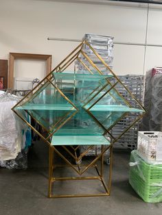 three glass tables stacked on top of each other in a room filled with plastic boxes