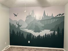 an empty room with a hogwarts mural on the wall