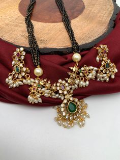 Four Line Guttapusalu CZ Red Green Stone and Pearls Mangalsutra Approx : 10 Inches;  Earrings Length Approx 1.5 Inches Temple Jewelry Chandbali Pearl Necklace For Party, Traditional Black Beaded Necklace For Party, Festive Kundan Necklace With Dangling Beads For Diwali, Traditional Kundan Necklace With Dangling Beads For Festive Occasions, Temple Jewelry Sets With Dangling Beads For Celebrations, Temple Jewelry Beaded Necklaces For Parties And Festivals, Festive Necklace With Black Beads For Festivals, Festive Jewelry Sets With Dangling Beads For Celebration, Multicolor Kundan Necklace With Dangling Beads For Wedding