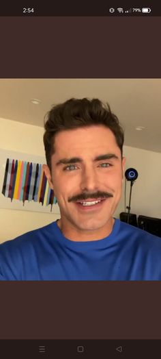 a man with a mustache and blue shirt