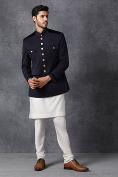 Dark blue bandhgala with front pockets detail.
Components: 1
Fabric: Suiting
Neckline: Band collar
Sleeve Length: Bracelet
Color: Blue
Lining material: Poly
Button placket on sleeve hems and pockets
Closure: Front button placket
Note: Kurta and pant worn by model are not for sale. - Aza Fashions Festive Formal Nehru Jacket With Button Closure, Festive Nehru Jacket With Button Closure, Traditional Nehru Jacket With Button Closure For Formal Events, Designer Nehru Jacket For Semi-formal Occasions, Formal Fitted Kurta With Buttons, Traditional Nehru Jacket With Buttons For Formal Occasions, Traditional Formal Nehru Jacket With Buttons, Traditional Formal Nehru Jacket, Designer Nehru Jacket For Festive Workwear