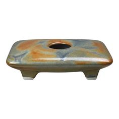 a ceramic soap dish with a hole in the middle