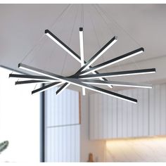 a modern chandelier hanging from the ceiling