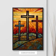 three crosses in stained glass with the sun shining behind them and grass on the ground