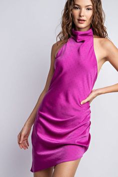 Step out in chic sophistication and style with this Magenta Satin Halter Mock Neck Mini Dress. Crafted from sumptuous satin fabric, this sleeveless mini dress is sure to make a statement with its halter neckline and cut-out back detail. Perfect for any special event, this stunning ensemble is sure to elevate your wardrobe. Fabric & fit: Model is wearing size Small. Chic Satin Halter Dress Mini Length, Satin Halter Neck Mini Dress For Date Night, Halter Neck Satin Finish Cocktail Dress, Satin High Neck Dress For Date Night, High Neck Satin Dress For Date Night, Glamorous Satin Finish Mini Dress For Cocktail, Glamorous Satin Finish Cocktail Mini Dress, Satin Halter Neck Mini Dress For Evening, Satin Mini Halter Dress For Night Out