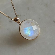 ITEM DESCRIPTION: This stunning necklace is set in 14k Solid Yellow Gold with Natural Rainbow Moonstone with utmost precision. It is an unique gemstone necklace for nearly every occasion and is completely hassle-free jewelry. ITEM DETAILS: * Gem: Rainbow Moonstone * Gem Size: 16x16mm * Gem Shape: Round * Gem Weight: 12.86 carats * Gold Purity: 14KT * Gold Weight: 0.50 gram * Total Weight: 3.07 gram The Gold purity is guaranteed and it comes with authentic 14KT gold hallmark. Since my items are h Yellow Gold Moonstone Jewelry With Birthstone, Oval Moonstone Necklace In Yellow Gold, Moonstone Round Pendant Jewelry For Anniversary, Moonstone Round Necklace For Gifts, Moonstone Round Necklace For Anniversary, Faceted Round Gemstones For Gift, Round Faceted Gemstones For Gifts, Round Moonstone Birthstone Jewelry, Yellow Gold Moonstone Gemstone Necklace