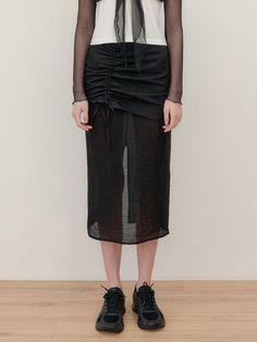 This sheer skirt offers a versatile and elegant style perfect for various occasions. It features the layered straight fit design for a sophisticated look.- Made with a combination of sheer twill fabric and textured contrast fabric- Adjustable drawstrings at the bottom of the skirt allowing for various styling options- H-line silhouette to add appeal to the item Sheer Nylon Skirt For Spring, Spring Sheer Nylon Skirt, Chic Sheer Stretch Skirt, Chic Long Sheer Skirt, Chic Ruched Pencil Skirt For Spring, Chic Sheer Midi Skirt, Chic Black Nylon Skirt, Chic Sheer Mini Skirt, Spring Nylon Pleated Skirt