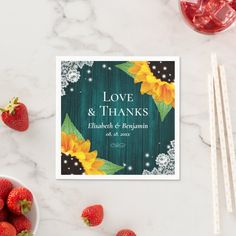 a card with sunflowers and leaves on it next to strawberries