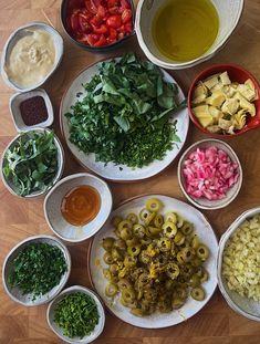 several bowls with different types of food in them sitting on a table next to each other