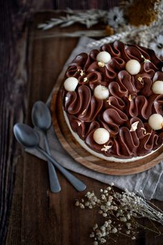 a cake with chocolate frosting and white decorations