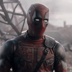 a deadpool character standing in the middle of a destroyed building with his hands on his hips