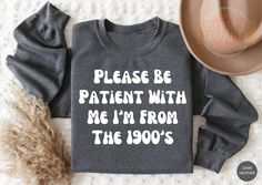 Please Be Patient With Me I'm From The 1900's Sweatshirt, Gaming Shirt, Trendy Sweatshirt,Western Graphic Tee,1900's Shirt,Funny Gift Friend Thank you for supporting our small business. Our main priority here is our customers. High quality and super soft, comfortable shirt. Made with DTF Printing. PLEASE CHECK SIZES AND COLORS BEFORE ORDERED ✅ I'm working with different brands based on availability. Different styles of shirts may have different shades of same color due to different manufacturer brands. If you have a preferred brand, please let me know. ✅ Since all shirts are custom made based on your selection, I don't accept RETURN or EXCHANGE unless there is an issue with your order. ✅ WASH item inside out in cold water, do not bleach, do not dry clean, do not iron directly on the design Vintage Long Sleeve Slogan Sweatshirt, Vintage Long Sleeve Tops With Lettering, Vintage Long Sleeve Slogan T-shirt, Vintage Long Sleeve T-shirt With Text Print, Vintage Long Sleeve T-shirt With Funny Print, Please Be Patient With Me, Sweatshirt Western, Olive Shirt, Western Graphic Tees