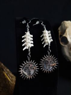 Here are some Beautiful Stainless Steel Sun earrings! They Were Made with Real Rattlesnake Vertebrae. These Earrings are Around 4 Inches Long. The Hooks and All are Stainless Steel. With Well Care, These Should Last for Years to Come. All Items Ship Within 1-3 Days via USPS Ground Advantage Service. Shipping on these will be 5.50 (USA Only) All additional items are FREE! International Shipping Will Be 22.00 + 2.00 For each Additional Item. Canada 20.00 + 2.00 For each Additional Item. International Shipping May Take 2 - 6 Weeks to Deliver I DO NOT Carry Human Bones or Any Sort of Illegal Items. And As Etsy Sellers, We Are Not Allowed to Sell Domesticated Dog or Cat Bones of Any Sort. All The Bones Here are Legal to Buy, Sell, And Own in the United States. Sun Witch, Cat Bones, Sun Jewelry, Sun Earrings, Celestial Earrings, Human Bones, Bone Earrings, Bone Jewelry, Signature Style