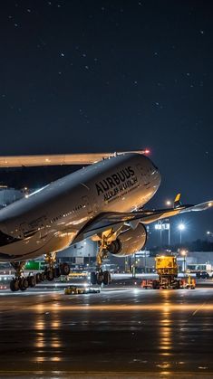 an airplane is on the runway at night