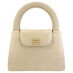 Store item: 68460 Chanel Vintage Beige Caviar Evening Mini Kelly Bag 24k GHW The "O.G." Kelly - one of our favorite vintage treasures is this Chanel Vintage Beige Caviar Evening Mini Kelly Bag 24k GHW. A wearable rare collectible for a Chanel maven's closet. A "mini" version of the classic Chanel Kelly, with two oversized "cutout" type handles and a small flap over closure with a turnlock CC clasp in 24k gold plated hardware. Back pocket adds practicality. Main compartment lined in lambskin and has two side pockets. Tres chic and perfect for evening or dinner, this very rare and hard to find piece will be sure to be one of your favorite wardrobe treasures. In Beige caviar leather and 24k gold plated hardware. This item is in great condition with few signs of normal use. Corners show light Mini Kelly Bag, Chanel Kelly, Fendi Mini, Mini Kelly, Classic Chanel, Hermes Kelly Bag, Shopping Photography, Kelly Bag, Crossbody Tote Bag