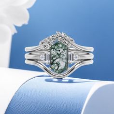 Discover our exquisite sterling silver engagement ring, designed for women who appreciate elegance and durability, featuring a stunning square moss agate gemstone, masterfully enhanced with a luxurious white gold plating that radiates brilliance. This exceptional engagement ring combines the timeless beauty of sterling silver with the unique allure of a square moss agate center stone, symbolizing pure love and commitment. The white gold plating adds an extra layer of sophistication and resilienc Luxury Engraved Agate Rings, Luxury Silver Moss Agate Ring, Square Engagement Ring, Moss Agate Jewelry, Square Engagement Rings, Silver Engagement Ring, Sterling Silver Wedding Rings, Moss Agate Ring, Custom Wedding Rings