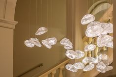 a chandelier hanging from the side of a staircase