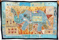 an elephant quilt hanging on the wall