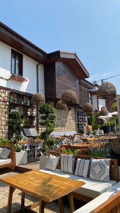 an outdoor seating area in front of a house