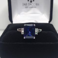 Beautiful Blue & Moissanite Diamond Ring * 4ct Emerald Cut Blue Sapphire measures 10mm x 8mm * 4 Brilliant Cut Moissanite Diamond Accents measure 2mm each (DEF VVS) * 4.28cts total Gemstone weight * 14k Yellow or White Gold - Select Your Color * Sized to Order - Select Your Size Hallmarked & Gift Ready! Matching Earrings & Ring Also Available! This Sapphire is Laboratory Grown. It is identical to natural in every way, including Chemistry, Composition & Hardness with Excellent Clarity & Color Ref Emerald Cut Sapphire Ring, Ring Emerald Cut, Blue Moissanite, Emerald Cut Diamond Ring, Diamond Wedding Rings Sets, White Sapphire Ring, Moissanite Diamond Rings, Fine Art Jewelry, Earrings Ring