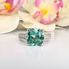 an oval cut green and white diamond ring