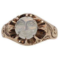 Rare Original Condition Victorian Man in the Moon Ring from the 19th Century in 14K gold. Original moonstone carved smiley face set high into pronged settings which give the appearance of sunburst with scrolls of clouds, hand engraved on shoulders of ring. Rare survival as rings of this sort were damaged if the wearer was wasnt careful as the moonstone cameo is mounted high. The adularescence (blue moon glow effect) comes from the upper left diagonally across the carving. Charming original Victo Ring Styling, Moon Carving, Victorian Man, Man In The Moon, In The Moon, Glow Effect, Moon Ring, Victorian Rings, Precious Jewels