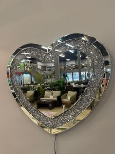 a heart shaped mirror hanging on the wall