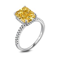 a yellow diamond ring with diamonds around it