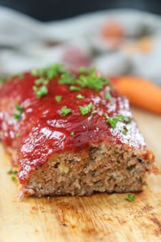 meatloaf with ketchup and parsley on a cutting board