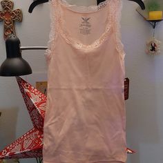 Baby Pink Camisole/ Tank Top With Lace Detail. Perfect For Layering. 94% Cotton, 6%Spandex. Brand New Never Worn. Feminine Sleeveless Tank Top With Built-in Bra, Fitted Sleeveless Tank Top For Loungewear, Stretch Tank Strap Tops For Loungewear, Pink Racerback Tank Top For Loungewear, Spring Racerback Stretch Camisole, Spring Stretch Racerback Camisole, Fitted Cami Tank Top For Loungewear, Stretch Racerback Camisole For Spring, Feminine Stretch Tank Top With Lace Trim