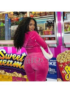 a woman standing in front of a candy bar