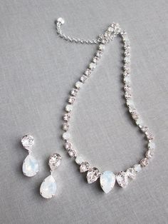 "This elegant necklace and the earrings set is hand made using fine Swarovski crystals in white opal and clear crystal mix. The necklace measures 16\" long and comes with the 2\" extender. The matching drop earrings measure 1 1/2\" long and 1/2\" wide. The set is available in gold, silver or rose gold finish. Also available with all clear crystals. - The listing is for the jewelry set only - For the matching belt please take a look here: https://www.etsy.com/listing/751689969/swarovski-crystal-b White Cubic Zirconia Jewelry Sets With Matching Earrings, White Sterling Silver Jewelry Sets With Elegant Design, Exquisite Crystal Jewelry With Matching Earrings, Elegant White Crystal Jewelry Sets, Dazzling White Jewelry Set With Sparkling Stones, Elegant White Bridal Necklace With Matching Earrings, White Cubic Zirconia Necklace With Matching Earrings, Elegant Gemstone Jewelry Sets For Wedding, Elegant Crystal Embellished Jewelry For Gifts