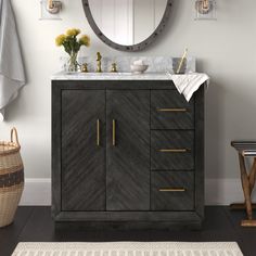 a bathroom vanity with a round mirror above it next to a rug and flowers on the floor