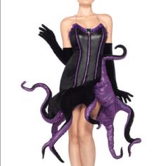 a woman in a purple and black costume with an octopus on her leg, standing