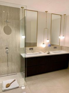 a bathroom with two sinks and a large mirror on the wall next to each other