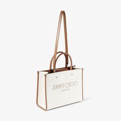 A modern yet timeless choice, our Avenue Tote arrives in recycled cotton canvas. Unmistakably Jimmy Choo, featuring our signature embroidered logo. Complete with a long detachable shoulder strap for versatile styling to be worn long or across the body. Practical and functional; it is comfortable to carry with easy interior access. Jimmy Choo Handbags, Jimmy Choo Bag, Stefano Gabbana, Natural Tan, Pocket Bag, Canvas Leather, Canvas Tote Bag, Recycled Cotton, Leather Handle