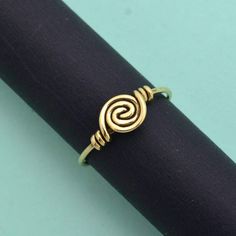 "Cute spiral ring of Brass, handcrafted and lightweight. Stack with other gemstone rings, or wear it alone. ❥ The spiral is one of the oldest symbols in the world. It appears in most ancient cultures across the globe and has many meanings, including progress, direction, and expansion. The Greeks related spirals to infinity, balance, and awareness. ❥ Benefits of Brass Metal : Brass has metaphysical healing properties to boost the immune system and to give courage. It's known to help reduce inflammation and also improve digestion. Brass has the properties of purifying negative energy.  The golden shine symbolizes the sun. It will be useful when you want to clear out shadiness in your mind. ❥ Our products are made of high-quality Brass metal and are carefully crafted by hand in our family wor Hand Forged Spiral Jewelry Gift, Symbolic Adjustable Spiral Jewelry, Adjustable Symbolic Spiral Jewelry, Minimalist Spiral Metal Ring Jewelry, Hand Forged Spiral Ring As Gift, Hand Forged Spiral Ring, Hand Forged Spiral Ring For Gift, Hand Forged Spiral Rings For Gifts, Adjustable Stackable Spiral Jewelry