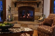 a living room filled with furniture and a fire place in front of a flat screen tv