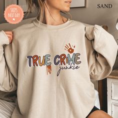 All of our True Crime Junkie hoodies are handmade to order on an ultra soft crewneck that will quickly become your go to apparel item! You will never want to take it off! Our True Crime sweatshirts are handmade to order with eco-friendly water based ink that feels good and lasts longer! ♥The details♥ This unisex sweatshirt is crafted from soft, breathable fabric for ultimate comfort. Printed with an eco-friendly water-based ink, this sweater not only looks great but also supports sustainable pra Funny Cotton Hoodie Sweatshirt, Funny Crew Neck Hoodie For Streetwear, Funny Long Sleeve Cotton Hoodie, Fan Apparel Long Sleeve Sweatshirt With Custom Print, Long Sleeve Sweatshirt With Custom Print For Fans, Funny Long Sleeve Cotton Sweatshirt, Crew Neck Hoodie With Custom Print For Fall, Custom Print Crew Neck Hoodie For Fall, Casual Hoodie With Custom Print For Fall