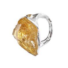 This enchanting ring by German Kabirski features a rough Citrine crystal believed to hold magical powers, serving as an amulet to protect against an ordinary mindset. Accented with yellow Sapphires, the crystal is set on a band plated with both White Rhodium and 18K Gold. Designed for those who embrace creativity and seek a unique expression, this piece is a fresh, artistic addition to any collection. Metal: 925 SilverStones: Rough Citrine, SapphirePlating: White Rhodium, 18K Gold  Please Note: Unique Citrine Gemstone Crystal Ring, Citrine Ring With Large Stone, Magical Powers, August Birthstone Jewelry, July Birthstone Jewelry, Fine Art Jewelry, Citrine Crystal, Jewelry Ring Box, Pearl Jewellery Earrings