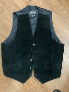 This Dual Control men's leather vest is a stylish piece that will make you stand out from the crowd. The black suede fabric gives it a luxurious feel, while the button closure adds a touch of sophistication. The mid-length design is perfect for casual, workwear, or travel occasions. The vest is part of the Classic theme and is suited for the winter, summer, fall, and spring seasons. It is made in China and fits regular, with a size type of regular. It is a perfect choice for riding, walking, or hiking. This vest does not have any personalized features and is not handmade. Casual Workwear, Mens Vests, Red Coat, Suede Fabric, Vest Outfits, Leather Vest, Classic Theme, Spring Season, Summer Fall