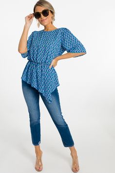 This blouse has us wishing we were on the coast of somewhere beautiful! With an elastic cinched waist + a wavy printed body, it's both flattering AND fun! Blouse offers a back button closure. Printed Blue Rayon Top, Blue Printed Rayon Top, Blue Top With Smocked Back And Stretch Fit, Blue Stretch Top With Smocked Back, Blue Short Sleeve Tops With Elastic Waistband, Flowy Smocked Back Blouse For Beach, Casual Tops With Gathered Waist And Short Sleeves, Fitted Blue Tops With Elastic Waistband, Blue Stretch Blouse For Day Out