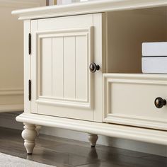 a white cabinet with two doors and drawers